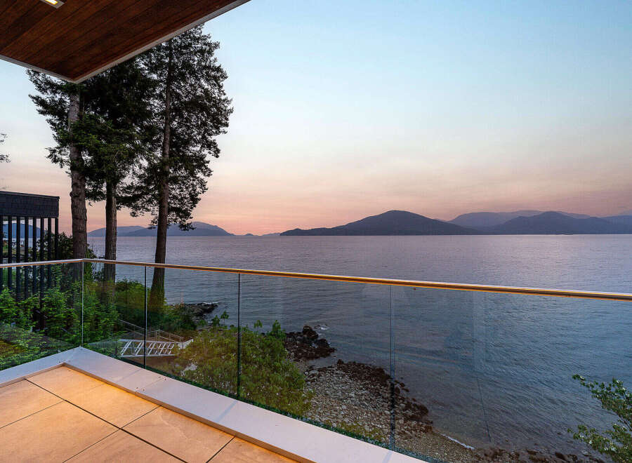 Experience breathtaking ocean views from this modern balcony, perfect for enjoying serene sunsets.