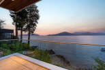 Experience breathtaking ocean views from this modern balcony, perfect for enjoying serene sunsets.
