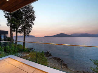 Experience breathtaking ocean views from this modern balcony, perfect for enjoying serene sunsets.