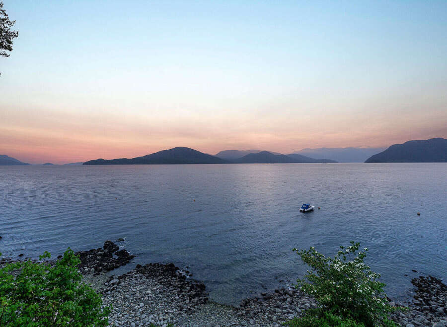 Experience breathtaking sunset views over the water from this stunning property.