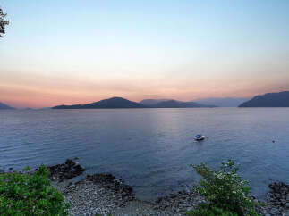 Experience breathtaking sunset views over the water from this stunning property.