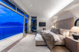 Experience unparalleled luxury in this master suite, featuring floor-to-ceiling windows that offer breathtaking ocean and mountain views.