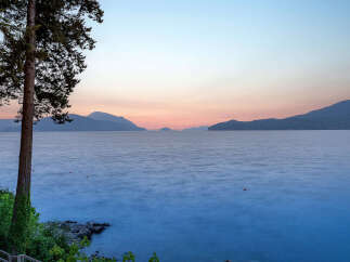 Experience breathtaking sunset views over the tranquil water from this stunning property.