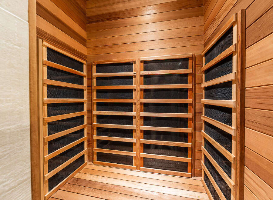 Experience ultimate relaxation in this luxurious sauna, featuring natural wood paneling and integrated heating elements.