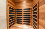 Experience ultimate relaxation in this luxurious sauna, featuring natural wood paneling and integrated heating elements.