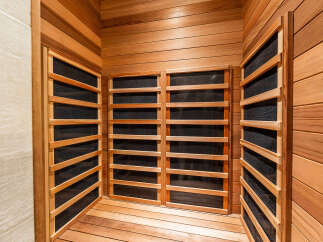 Experience ultimate relaxation in this luxurious sauna, featuring natural wood paneling and integrated heating elements.