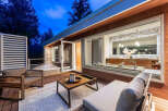 Experience modern luxury with this stunning outdoor living space, featuring a sleek deck and comfortable seating perfect for relaxation.