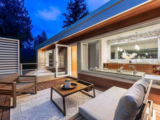 Experience modern luxury with this stunning outdoor living space, featuring a sleek deck and comfortable seating perfect for relaxation.