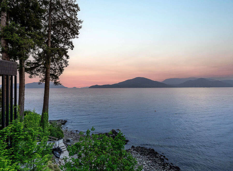 Experience breathtaking sunset views over the water from this stunning property.