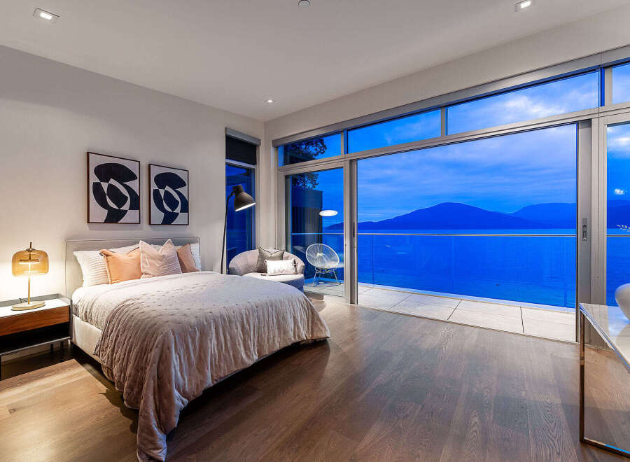 Experience luxury living in this stunning bedroom featuring a plush king-sized bed and elegant decor.