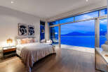 Experience luxury living in this stunning bedroom featuring a plush king-sized bed and elegant decor.