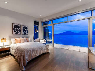 Experience luxury living in this stunning bedroom featuring a plush king-sized bed and elegant decor.
