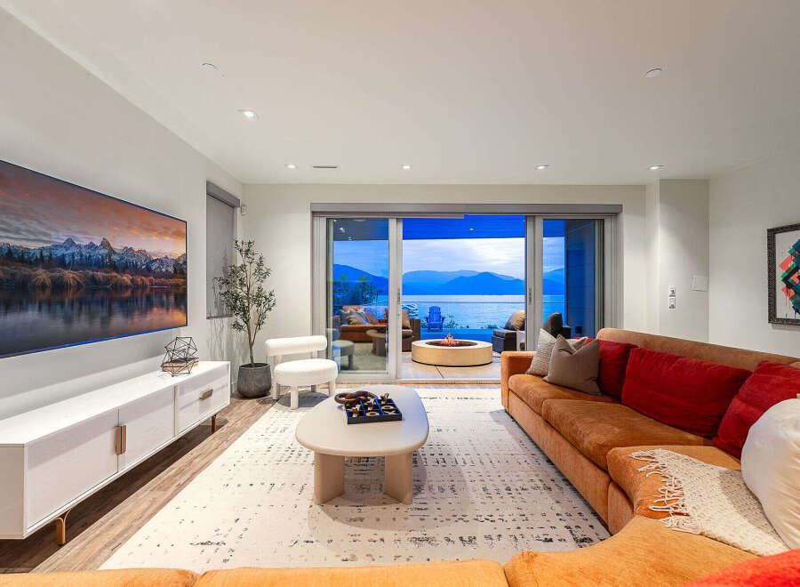 Experience luxurious living with this stunning living room, featuring a large sectional sofa and a modern entertainment center.