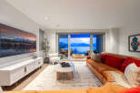 Experience luxurious living with this stunning living room, featuring a large sectional sofa and a modern entertainment center.