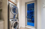 Discover a functional laundry space featuring a sleek, stacked Samsung washer and dryer set.