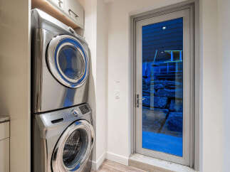 Discover a functional laundry space featuring a sleek, stacked Samsung washer and dryer set.