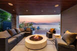 Experience breathtaking sunset views from this luxurious outdoor living space, complete with a modern fire pit and comfortable seating.
