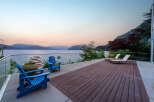 Experience breathtaking waterfront living with this stunning property, featuring a spacious deck perfect for entertaining and relaxation.