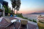 Experience breathtaking sunset views from this modern waterfront property.