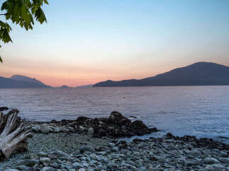 Experience breathtaking sunset views over the water from this stunning coastal property.