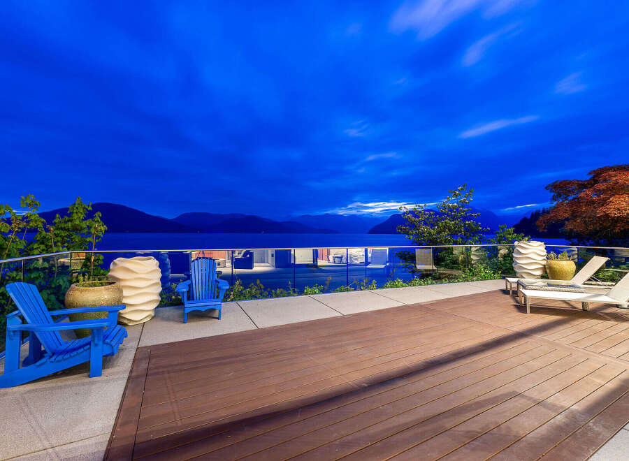 Experience breathtaking twilight views from this stunning waterfront property, featuring a spacious deck perfect for relaxation and entertaining.