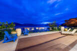 Experience breathtaking twilight views from this stunning waterfront property, featuring a spacious deck perfect for relaxation and entertaining.
