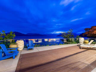 Experience breathtaking twilight views from this stunning waterfront property, featuring a spacious deck perfect for relaxation and entertaining.