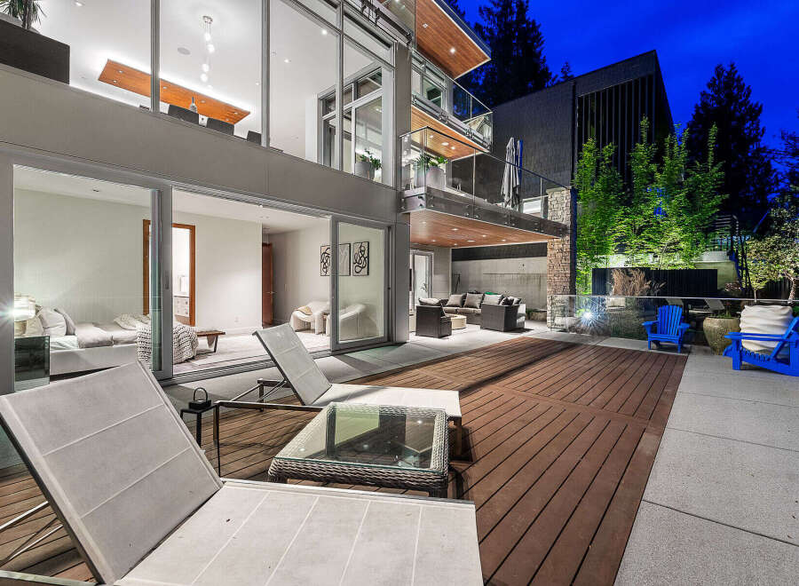 Experience modern luxury in this stunning multi-level home, featuring expansive glass walls that seamlessly blend indoor and outdoor living.