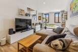 Experience modern living in this stylish living room, featuring a large sectional sofa perfect for relaxation and entertainment.