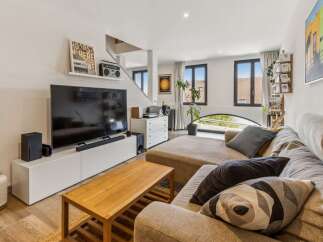 Experience modern living in this stylish living room, featuring a large sectional sofa perfect for relaxation and entertainment.