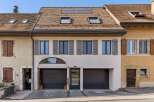 Discover this charming property featuring a modern facade with two spacious garage doors and a central entrance.