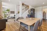 Discover this inviting dining area featuring a light wood table with comfortable upholstered chairs, perfect for family meals.