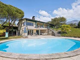 Enjoy a luxurious lifestyle with this stunning property featuring a large, sparkling swimming pool perfect for relaxation and entertainment.