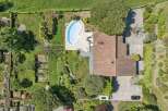 Discover this stunning property featuring a kidney-shaped swimming pool surrounded by a paved patio, perfect for relaxation and entertaining.