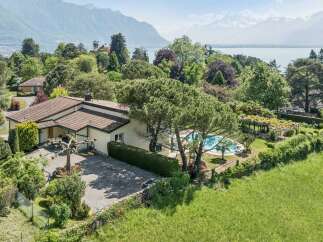 Discover this stunning property offering breathtaking panoramic views of the lake and majestic mountains.