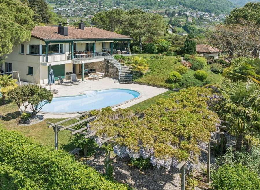 Discover this stunning property featuring a beautiful swimming pool and lush gardens, perfect for relaxation and entertaining.