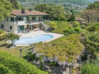 Discover this stunning property featuring a beautiful swimming pool and lush gardens, perfect for relaxation and entertaining.