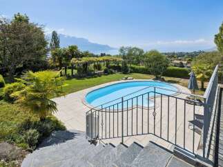 Experience luxurious outdoor living with this stunning property featuring a private swimming pool and expansive patio area, perfect for relaxation and entertainment.