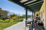 Enjoy breathtaking lake and mountain views from this stunning covered patio, perfect for al fresco dining or relaxing with a view.