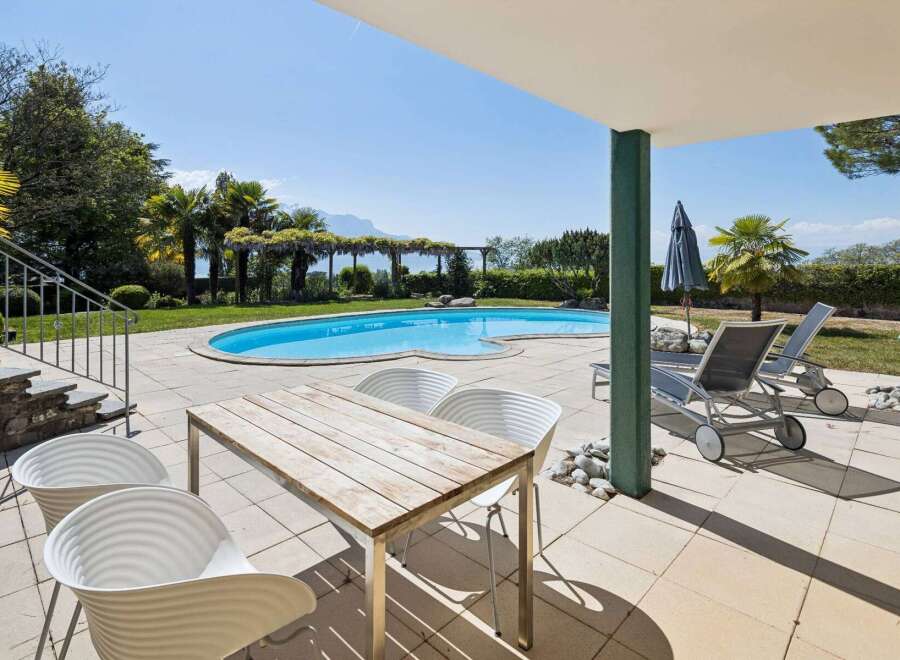 Enjoy ultimate relaxation by this stunning kidney-shaped swimming pool, perfect for a refreshing dip on a sunny day.