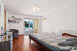 Experience luxurious living with this stunning bedroom featuring a spacious bed and direct access to a beautiful outdoor pool and garden area.