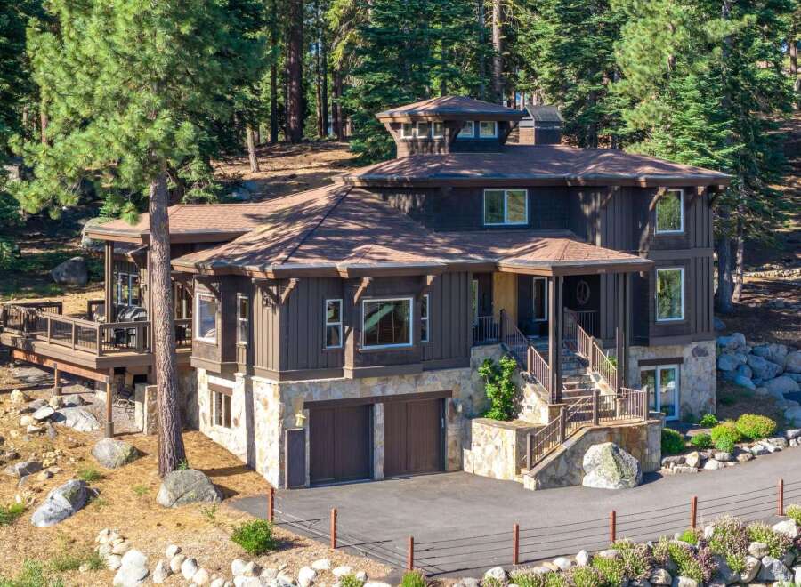 Nestled amidst towering pines, this stunning mountain home offers a luxurious retreat with its multi-level design and natural stone accents.