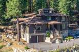 Nestled amidst towering pines, this stunning mountain home offers a luxurious retreat with its multi-level design and natural stone accents.