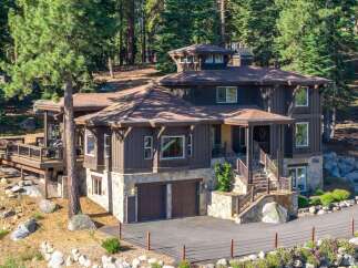 Nestled amidst towering pines, this stunning mountain home offers a luxurious retreat with its multi-level design and natural stone accents.