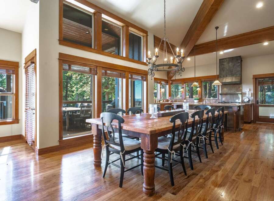 Experience luxurious mountain living in this stunning dining room, featuring a grand wooden table with seating for ten, perfect for hosting memorable gatherings.