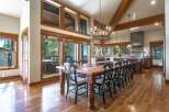 Experience luxurious mountain living in this stunning dining room, featuring a grand wooden table with seating for ten, perfect for hosting memorable gatherings.