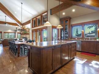 Experience luxurious mountain living in this stunning open-concept kitchen and dining area.