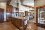 Experience rustic elegance in this spacious kitchen featuring custom wood cabinetry and a large granite island perfect for entertaining.