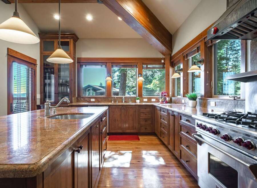 Experience rustic elegance in this spacious kitchen, featuring warm wooden cabinetry and granite countertops.