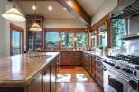 Experience rustic elegance in this spacious kitchen, featuring warm wooden cabinetry and granite countertops.